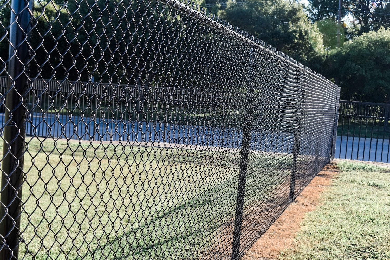 Black chain link fence by Gladiator Fence & Outdoors