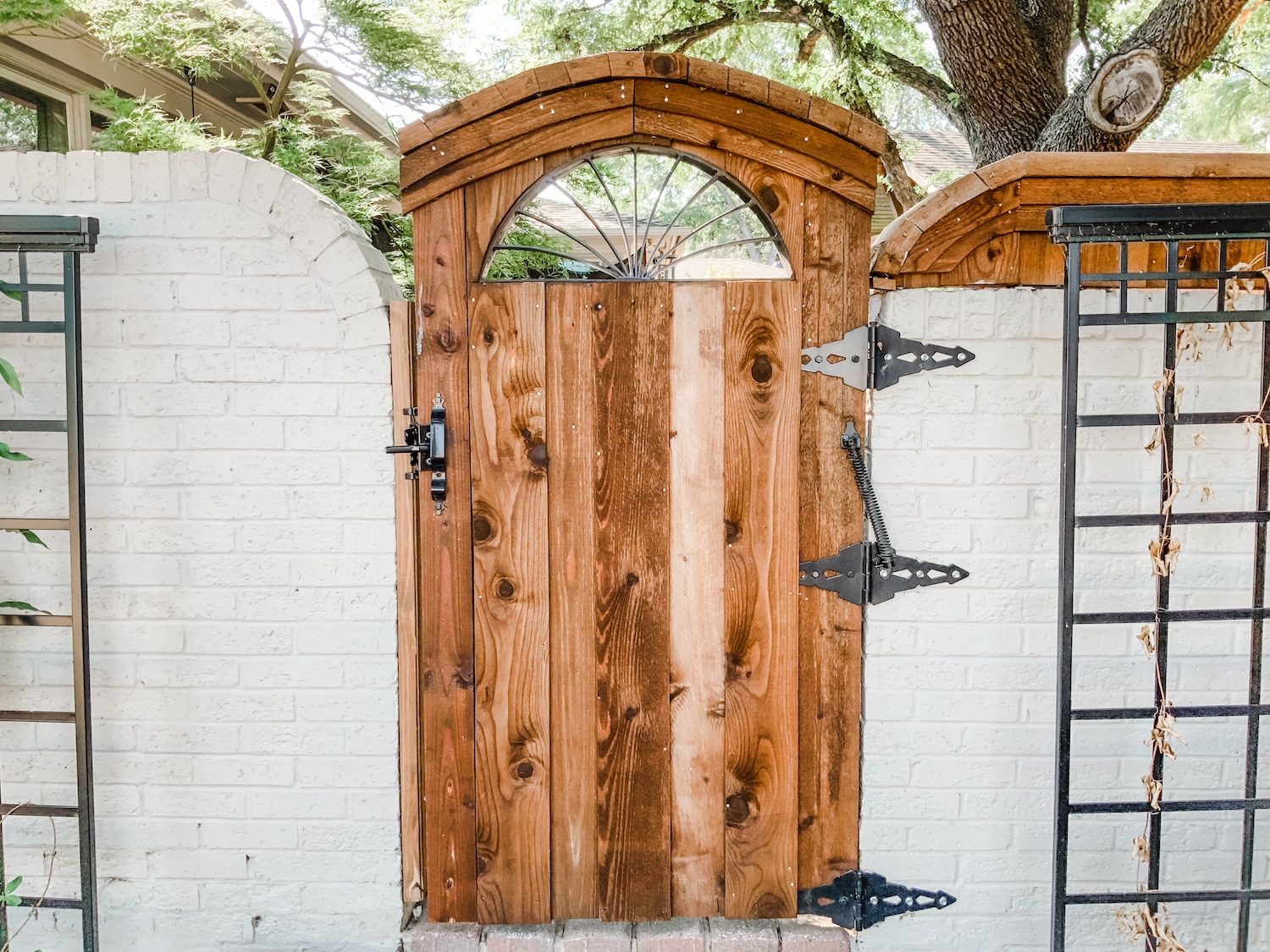 Decorative gate on brick by Gladiator Fence & Outdoors